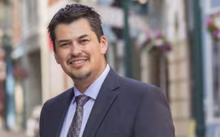 A smiling J. Ramon Gil-Garcia in a suit jacket and tie