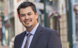 A smiling J. Ramon Gil-Garcia in a suit jacket and tie