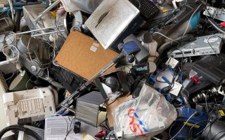 a pile of discarede lams, wires, computer parts and other electric and electronic devises