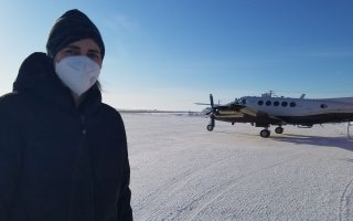Sara Lance stands in front of research aircraft used during the airborne field campaign in the Arctic.