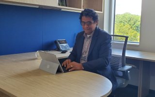 Jorge E. González-Cruz sits at his desk inside ETEC.