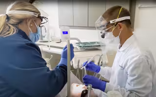 A dental team provides care to a patient at Apple Tree Dental in Minnesota.