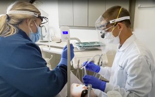 A dental team provides care to a patient at Apple Tree Dental in Minnesota.