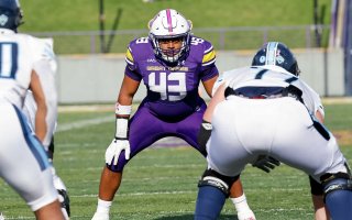 UAlbany football player Jackson Ambush gets ready to make a play.