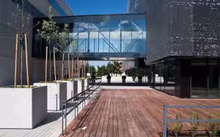 An elevated glass walkway between buildings at Tallinn University of Technology in Estonia.