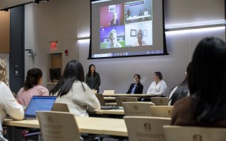 Students attend the Women in Tech panel discussion inside an ETEC conference room.