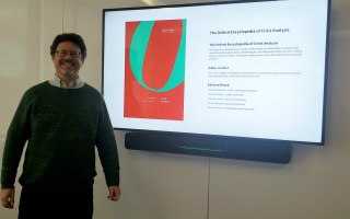 CEHC's Eric Stern stands in front of a display of the online version of the Oxford Encyclopedia of Crisis Analysis.