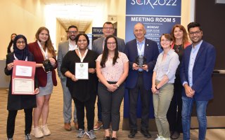 Lednev and two generations of his student researchers accept awards at the Great Scientific Exchange conference in Covington, Ky.