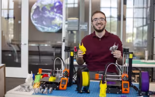Robert Shepherd displays 3D-printed Damien head statues.