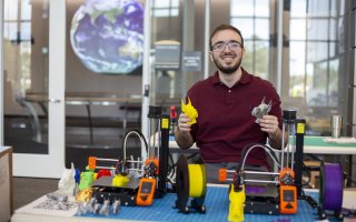 Robert Shepherd displays 3D-printed Damien head statues.