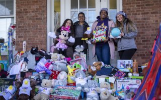UAlbany students surrounded by gifts at the Northern Rivers location in Albany.