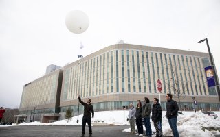 UAlbany student interns launch a weather balloon from the back parking lot of ETEC.