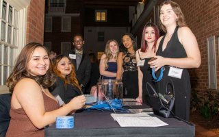 Five Quad members and alums gathered for a formal gala to celebrate the organization's 50th anniversary. 