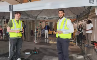 CEHC students Jay Parker and Hadley Santos control drones and robotics in the pop up tent at ETEC.