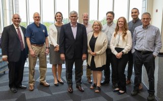 PNNL and DHS leaders stand with CEHC faculty at the ETEC atrium.