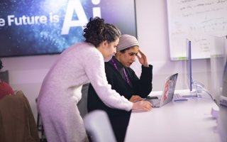 Graduate student researchers Mahsa Goodarzi and Rawan AlMakinah work together at CEHC’s AI in Complex Systems Lab.