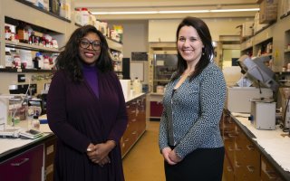 Rabi Musah and Allix Coon stand together in a chemistry lab.