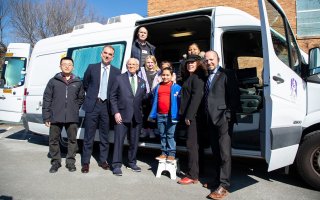 Students at the Giffen Memorial Elementary School stand with Congressman Tonko, UAlbany researchers and other officials in front of a mobile laboratory.