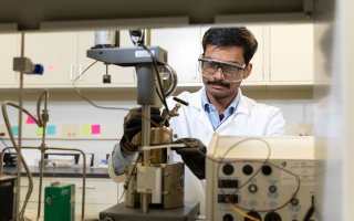 UAlbany PhD Student Sri Saravana Konganapuram Narasimma Bharathi works on a device in the lab of CNSE Professor Kathleen Dunn.