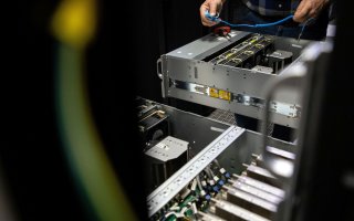 hands are seen installing computer units