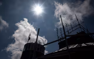 The sun shines over the Whiteface Mountain Field Station atop the summit.