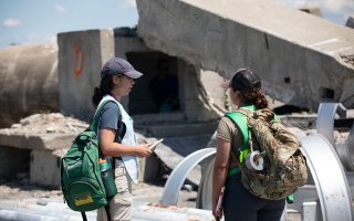 Students assess the damage of a collapsed building during a search and rescue simulation at the State Preparedness Training Center. 