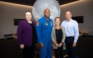CNSE Dean Michele J. Grimm, Former NASA Astronaut Leland Melvin, Caryn Bunshaft '82, and Albert Bunshaft '80 have their photo taken in the Sphere Room at UAlbany's ETEC.