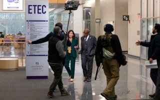 Gov. Hochul and Al Roker walk through the ETEC atrium with the TODAY Show production crew.