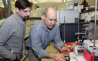 UAlbany researchers Ben Taubner and Nate Cady work on a semiconductor device in Dr. Cady's lab at the College of Nanotechnology, Science, and Engineering at the University at Albany.