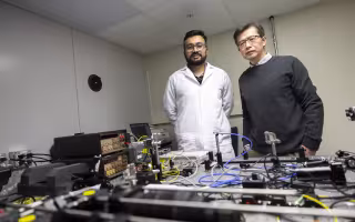 University at Albany Department of Nanoscale Science & Engineering Professor Mengbing Huang and doctoral student Sahyadri Anil Patil demonstrate a reliable ion implantation cladding method for sapphire optics fiber.