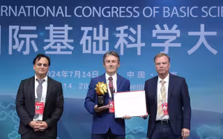 UAlbany Professor of Matheamtics Antun Milas, center, receives an award from the 2024 ICB Congress in Beijing. (Photo provided))