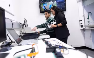 Jeremy Varghese and Aishwari Talhan conduct research at the Immersion lab.