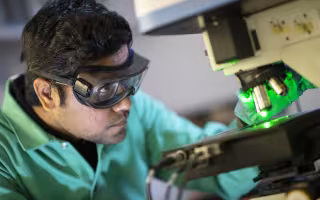 Student working with a microscope