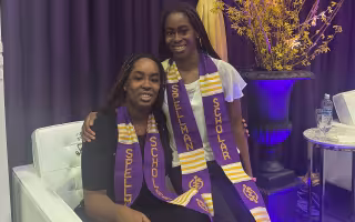 Kehinde and Taiwo Adejumo sit together wearing Seth Spellman Scholar stoles.