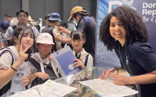 Sota Kojima stands with children at Expo 2025 Osaka-Kansai.