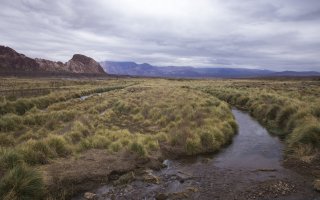 A small body of water overlooks the mountains in Mendoza, Argentina.