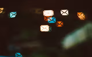 a graphic of small envelopes for e-mail over a digital distorted screen.