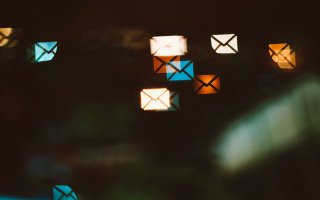 a graphic of small envelopes for e-mail over a digital distorted screen.