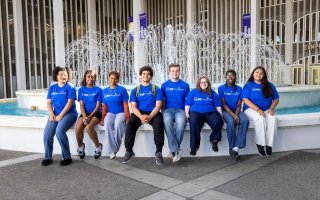 A group of UAlbany's ACE students sit by the Campus Center fountain