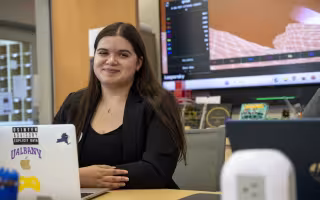 Olivia BenAoumeur sits behind a laptop in the Cybersecurity and Cryptography Lab.