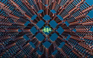 Computer rendering of a metal-organic framework. The image features a lattice of brown rods and blue nodes, arranged in a 3D crosshair pattern. In the center is a shape made of green rods and green nodes in a cluster, trapped in a central square. 