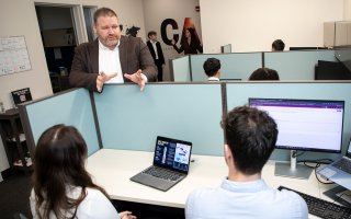 Brandon Behlendorf talks with students inside the Center for Advanced Red Teaming at ETEC.