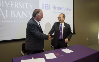 UAlbany President and Broadview CEO shake hands following signing agreement 
