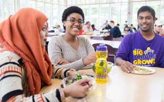 Students sitting at a table enjoying lunch together