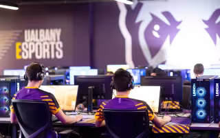 Students play PC games from inside the UAlbany Esports arena.