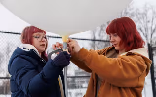 UAlbany students prepare a weather balloon for launch from the ETEC parking lot.