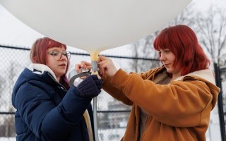 UAlbany students prepare a weather balloon for launch from the ETEC parking lot.
