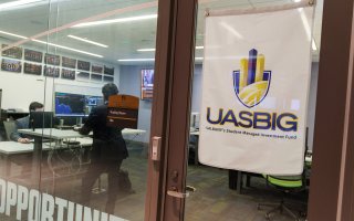 A sign outside of the Bloomberg room at UAlbany's Massry School of Business reads UASBIG for the student investment group.