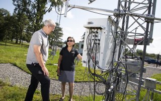 Chris Thorncroft and June Wang look at Mesonet instrumentation from inside the ETEC yard.