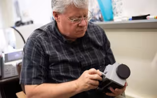 Kevin Knuth holds a device to study unidentified anomalous phenomena.